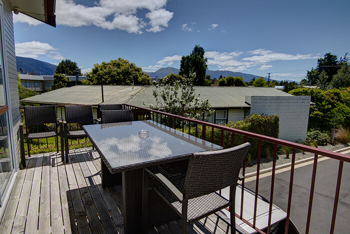 First storey balcony with table and chairs at Red Tussock motel, Te Anau